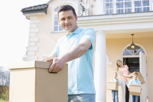 Man with van service helping with a move in Stratford near local residential buildings