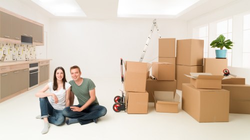 Movers loading boxed household items for transport